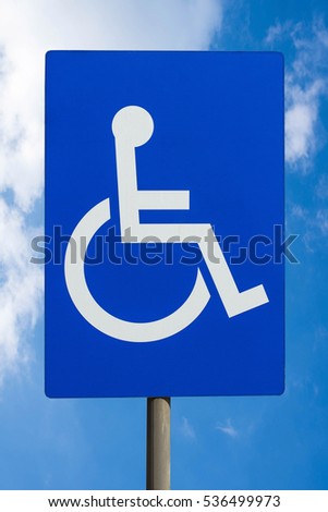 Signs for disabled with blue sky background
