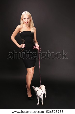 Beautiful girl with cute dog on dark background