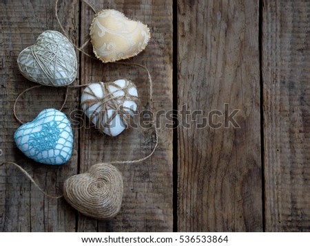 Valentine's Day concept. Composition of colourful handmade hearts on wooden background. Needlework. Copy space. Selective focus