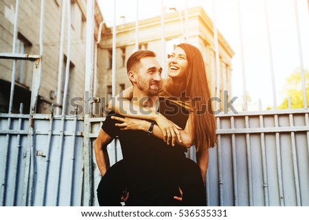Young beautiful stylish fashion couple at the old city, background iron gate