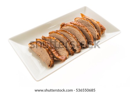 Grilled duck meat in white plate isolated on white background
