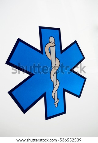 Traditional blue medical sign for ambulance, isolated on a white background and taken from side.