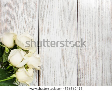 White roses on a old white wooden table