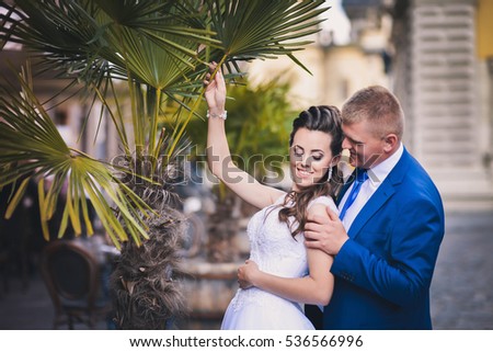 Wedding portrait of the bride, newlyweds, photo in the street. Bouquet, dress, happiness, city.