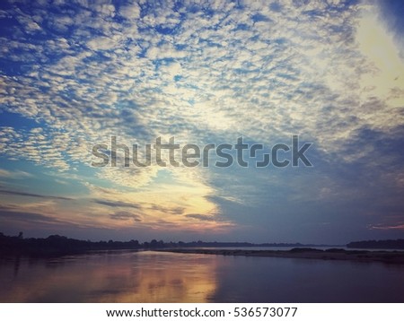 Sky clouds at sunset on the river. Feeling lonely and warm