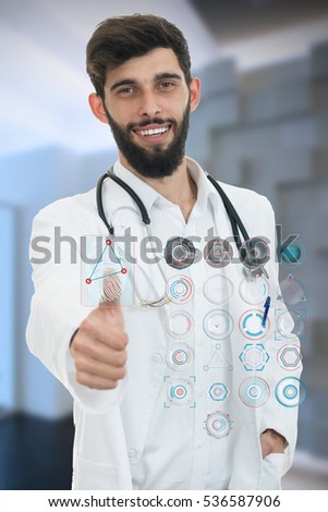 friendly male doctor showing thumbs up in hospital