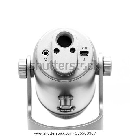 Close up bottom of microphone isolated on white background. Modern space grey USB microphone with usb, audio connection and arm/boom stand mount for podcast, broadcasting or voice over works.