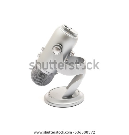Close up of microphone fold down isolated on white background. Modern space grey USB microphone with recording control buttons for podcast, broadcasting or voice over works.