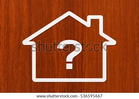 Paper house with question sign inside. Abstract conceptual image.