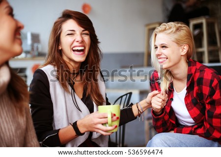 Friends having fun in a cafe. Royalty-Free Stock Photo #536596474