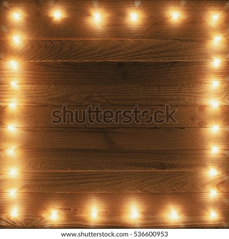 Christmas lights. Holiday frame on wood