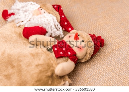 Santa and snowman handmade toy christmas decoration on rope background