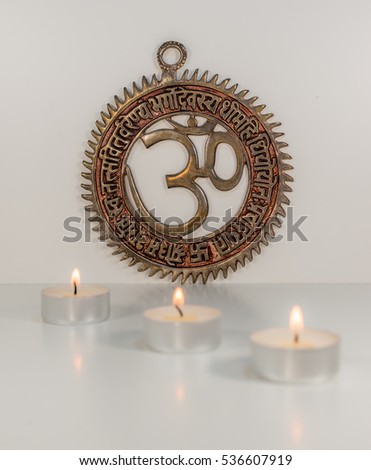 Om sign with burning candles - Indian special mantra - white background