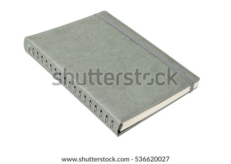 Grey leather spiral notebook with elastic band on white background
