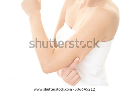 Woman checking her upper arm Royalty-Free Stock Photo #536645212