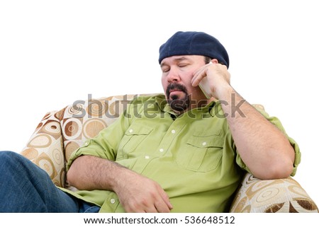 Bored overweight man in an armchair using a mobile, white background