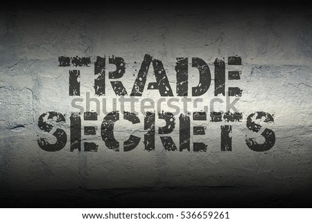 trade secrets stencil print on the grunge white brick wall 