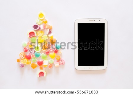 Candies Christmas tree with tablet, top view