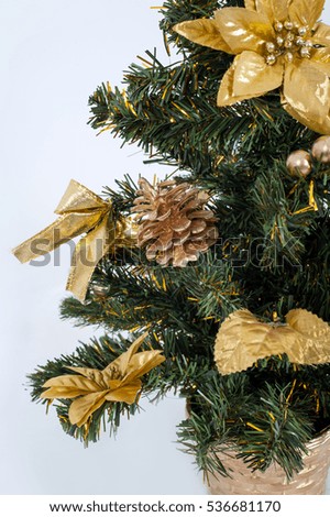Golden Christmas decorations on the spruce branches