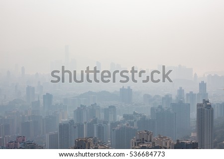 Hong kong tall buildings in haze at day Royalty-Free Stock Photo #536684773