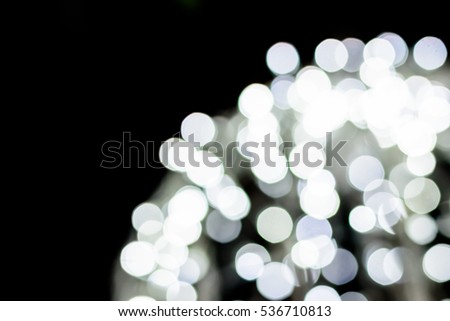 lighting white bokeh in dark night background.