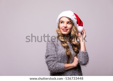 Smiling happy girl in Christmas Santa hat isolated on white background