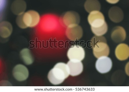 Blurred background of Christmas lights in the park with table surface