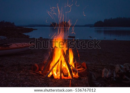 Campfire evening.  Kayak camping in the Broken Group Islands off the west coast of Vancouver Island. Royalty-Free Stock Photo #536767012