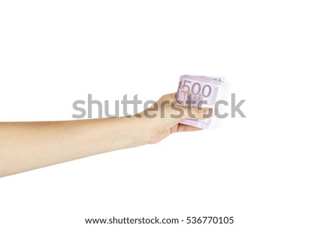 Isolated female's hand holds stack of euro on white background.