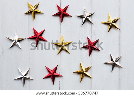 Christmas stars on white wooden background. Flat laying in top view