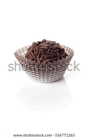 A brigadier, a Brazilian sweet, over a white background.