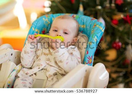 Baby girl in her feeding seat