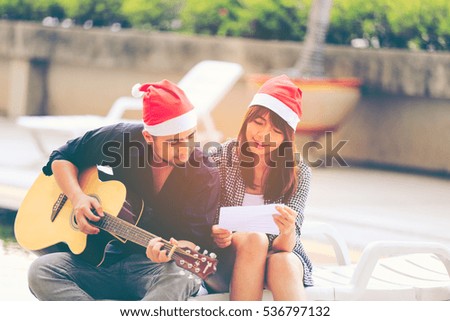  Young man playing guitar for his beloved girl soft effect for background