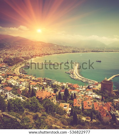 View of Alanya bay:coastline, city, red tower, lighthouse. Mediterranean sea. Turkey. Filtered image:cross processed vintage effect. 