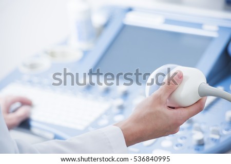 young woman doctor's hands close up preparing for an ultrasound device scan. Royalty-Free Stock Photo #536840995