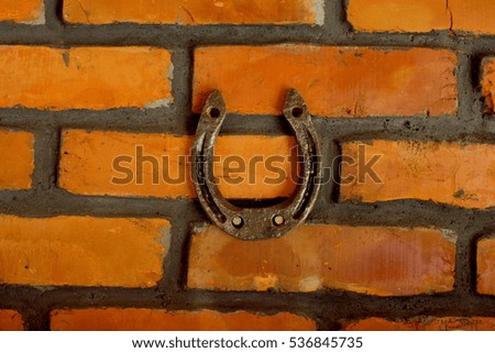 Horseshoe on a background of a brick