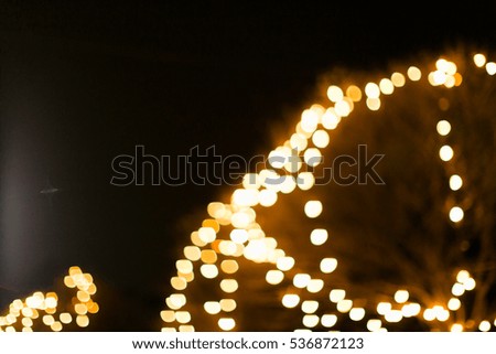 Christmas lights or Christmas decoration background with golden lights glowing