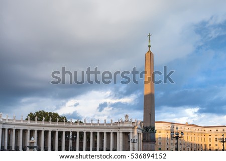 travel to Italy - obelisk with cross and Bernini's colonnade on Saint Peter's Square (Piazza San Pietro) in Vatican city in evening