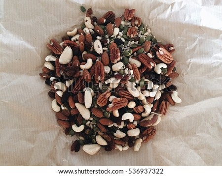 Nuts mix in a paper wrap. Toned picture, food background. Healthy food