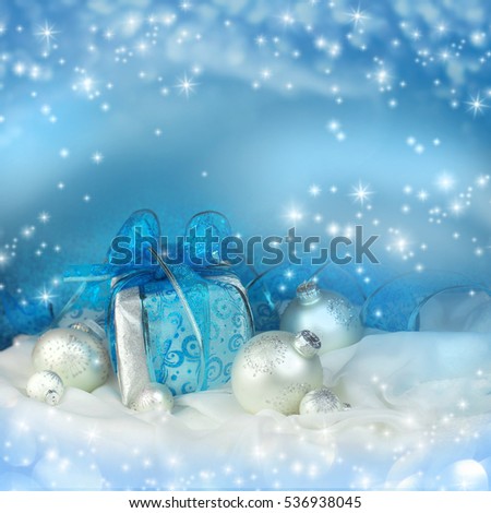 Christmas gift and decoration on blue background.
