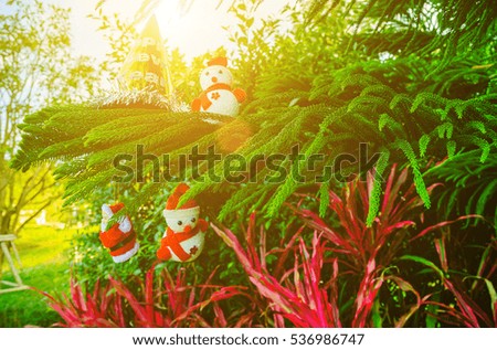 Snowman on a Christmas tree On a sunny day.