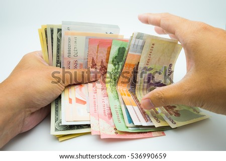 Various bank note with a hand trying to grab one
