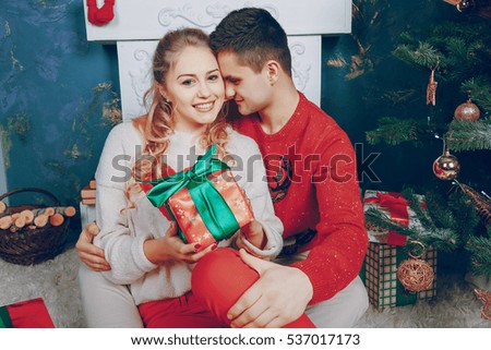 loving couple decorating Christmas tree. give gifts
