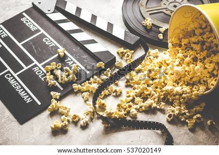 watching movie with popcorn on gray background close up