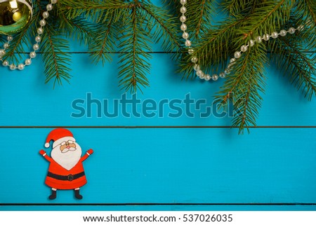 Handmade wooden Christmas tree decorations (Santa, Angel, Christmas tree, snowman) on a blue vintage table with Christmas tree. With blank and free space.