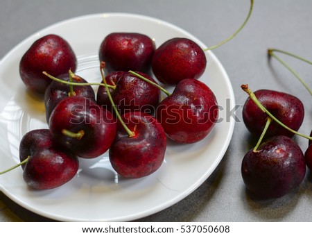 Fresh cherry fruits on the stone floor, closed up.