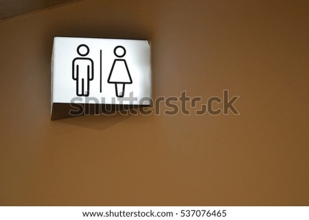 toilet sign on the wall at the airport