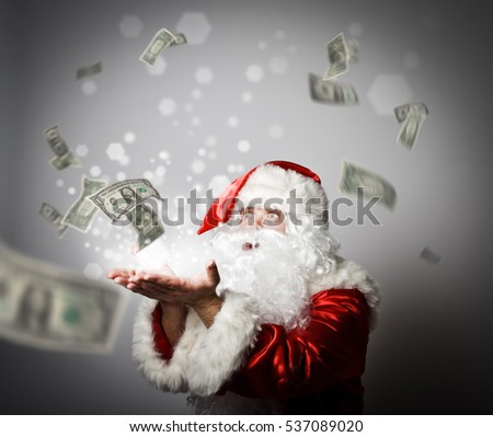 Santa Claus is blowing dollars. With best wishes for the New Year. Ironic picture. Miracle concept.