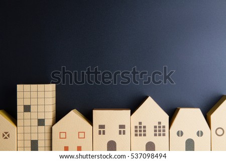 Home architectural model paper box cubes on black background with copy space.Real estate concept. Royalty-Free Stock Photo #537098494