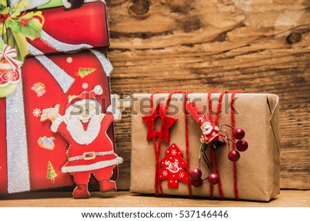 Christmas Santa Claus and gift box on wooden background. empty copy space for inscription. 